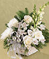 
Still and serene as a crisp morning snow, this basket of white blossoms - Fuji mums, roses, snapdragons and alstroemeria - show brightly against rich Christmas greens...
			