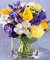 
Deep purple iris and lisianthus mingle with bright yellow tulips, pastel yellow carnations and white alstroemeria...
			