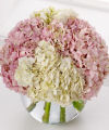 
Luxuriant pink and white hydrangea blooms crown a clear glass bubble bowl in this lush, overflowing bouquet...
			