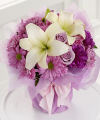 
It's her favorite color! Lovely lavender roses, lavender cushion and daisy pompons, and lavender carnations frame pure white lilies in this enchanting bouquet...
			