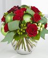 
Bursting with bright seasonal color, this bouquet boasts both red roses and spray roses whimsically accented with green hypericum berries, green glass holiday balls and green taffeta ribbon, artfully...
			
