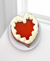 
Scrumptious creamy white chocolate cheesecake is topped with a red raspberry mirror and a border of whipped cream on a dark chocolate crust in a decorative heart-shaped container to create an indulgen...
			